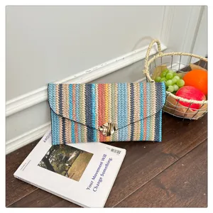 Colorful woven stripe clutch bag for women, stylish ethnic envelope handbag for daily wear.