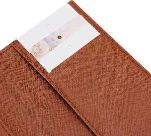 Brown PU leather passport holder detail shot showing fine textured surface and card slot.