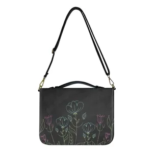 Sac bandoulière noir avec motif floral coloré, sangle réglable et poignée pratique.