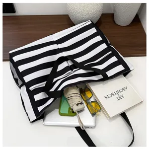 Detailed view of black and white striped tote bag with side mesh pockets and large capacity.