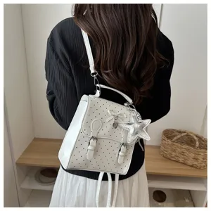 White polka dot backpack for women, casual college style bag with cute star pendant and bow.