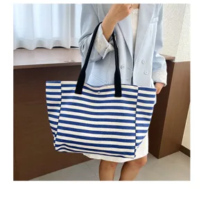 Large capacity striped canvas tote bag for women, casual commuter handbag for daily use.