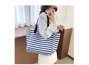 Detail view of commuter canvas tote bag featuring classic blue and white stripes design.