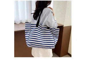 Detailed view of blue white striped canvas tote bag, large capacity commuter shoulder bag.