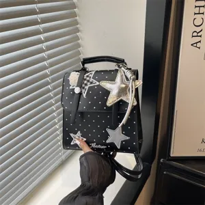 Black polka dot school backpack for women, stylish star charm handbag and casual daypack.