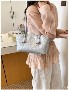 Silver metallic underarm shoulder bag for women, stylish minimalist tote bag for daily commute.