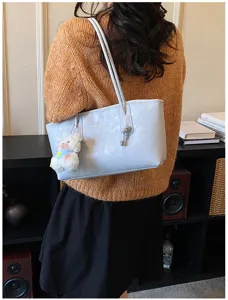 Minimalist PU leather shoulder tote bag for women, retro commuting large capacity handbag.