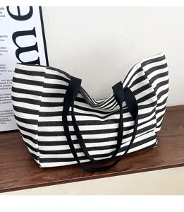 Black and white striped canvas tote bag, large capacity shoulder handbag for daily commute.