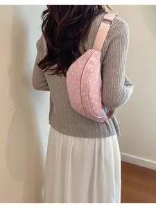 Pink polka dot fanny pack for women, casual chest bag and versatile waist bag detail view.