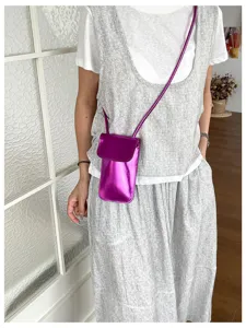 Shiny metallic purple mini phone crossbody bag, trendy women's vertical shoulder detail shot.