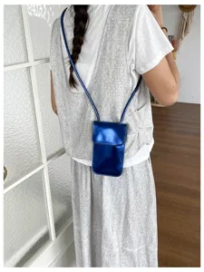 Glossy blue vertical phone bag detail, elegant small crossbody bag for women spring style.