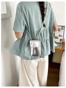 Detail view of silver glossy vertical mobile phone mini square bag for women stylish.