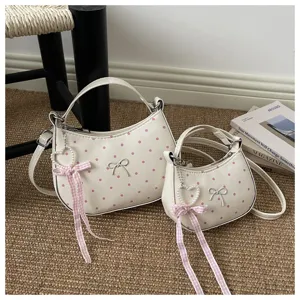 White polka dot dumpling handbag set with cute bow and pearl ribbon pendant detail style.