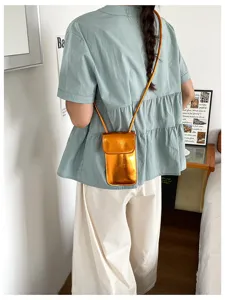 Shiny metallic vertical phone bag for women, trendy chic mini crossbody bag for daily wear.