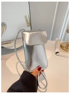 Silver shiny vertical phone crossbody bag, compact mini square purse with thin strap.