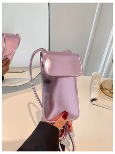 Glossy pink metallic vertical phone bag detail, stylish mini crossbody bag for women.