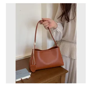 Brown PU leather underarm shoulder bag, stylish casual commuter handbag for women's daily wear.
