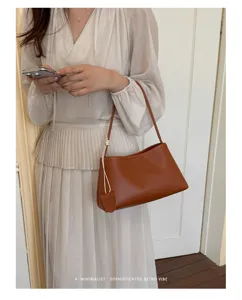 Minimalist brown shoulder underarm bag detail, sleek leather design for daily commute style.