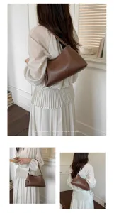 Minimalist brown leather shoulder bag for women, chic retro underarm tote for daily commute.