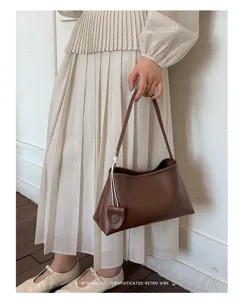Stylish brown underarm shoulder bag for women, minimalist design for daily commuting and fashion.