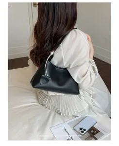 Detailed view of a chic black leather underarm shoulder bag with elegant drawstring design.