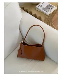 Minimalist brown leather shoulder bag for women, chic underarm handbag for daily commute.