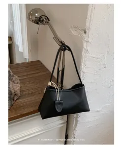 Minimalist black shoulder bag detail, elegant retro underarm design with chic strap accent.