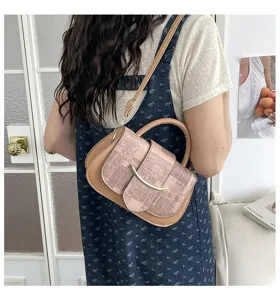 Bolso de hombro retro para mujer con diseño empalmado y hebilla metálica vista de detalle.