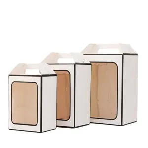 Set of three white paper gift boxes with transparent windows and handles in various sizes