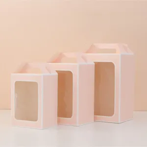 Set of three pink portable paper gift bags with transparent windows in various sizes