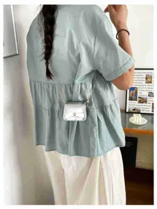 Mini silver metallic crossbody bag detail, stylish fashion accessory for daily wear