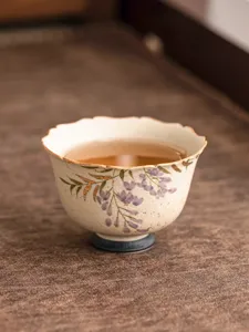 Ceramic tea cup with gold-traced wisteria flowers, elegant master tasting cup for home and office use.