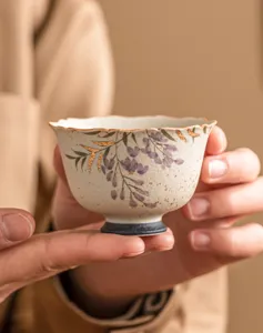 Handcrafted ceramic tea cup with gold wisteria flower, perfect for daily tea tasting and home use.