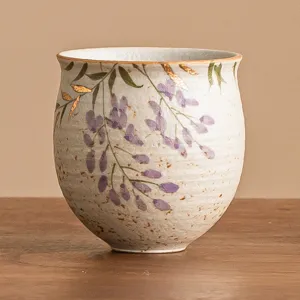 Exquisite hand-painted ceramic tea cup featuring elegant purple wisteria and gold accents.