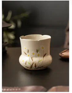Hand-painted daisy ceramic tea waste cup tea ceremony accessory detail view elegant design.