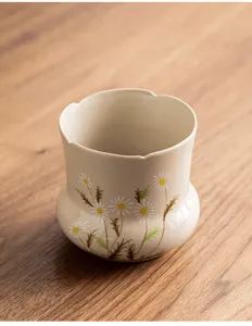 Hand-painted ceramic tea wash cup with lovely daisy floral pattern, elegant table decor.