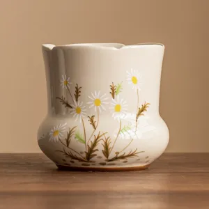 Hand-painted ceramic tea wash bowl with daisy pattern, elegant tea ceremony accessory.