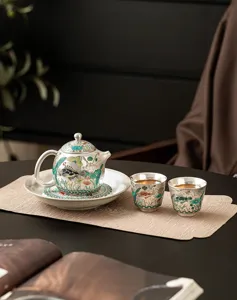 Elegant gilt-silver fish and algae pattern tea set, traditional Chinese ceramic teapot and cups.