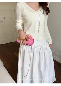 Chic pink shoulder bag with metallic handle, minimalist design for women commute daily wear.