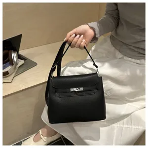 Sac à main noir en cuir texturé avec poignée supérieure et fermeture métallique, rétro chic.