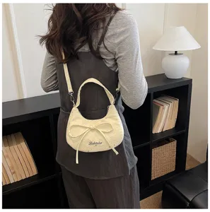 Stylish women's hobo dumpling bag with bow and rhinestones, versatile crossbody and chic handbag.