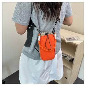 Lässige Canvas Umhängetasche für Damen, orangefarbene Handytasche mit verstellbarem Gurt.