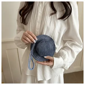 Close-up detail view of creative denim hat coin purse, mini storage pouch with cute strap.