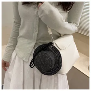 Creative denim bucket hat coin purse pendant with white shoulder bag and stylish outfit.