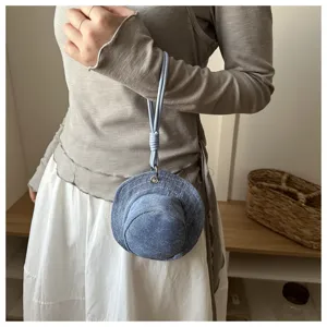 Mini denim hat coin purse pendant detail shot showcasing unique creative design and blue fabric.