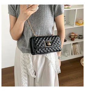 Black quilted chain shoulder bag, stylish patent leather crossbody purse with metal lock.