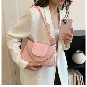 Dettaglio borsa a spalla rosa, design vintage con catena e stile elegante per donne.