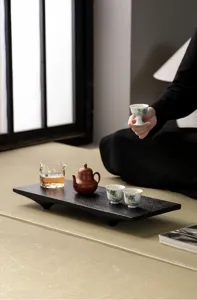 Wabi-sabi style wooden tea tray detail, carbonized walnut finish with four short feet.