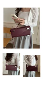 Elegante bordeauxlederen handtas met metalen sluiting, handvat en schouderband voor dames.
