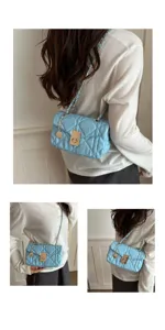 Light blue quilted shoulder bag detail, elegant chain strap and metal turn lock design shot.